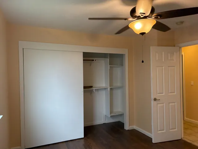 a view of a hardwood and an empty room with wooden floor