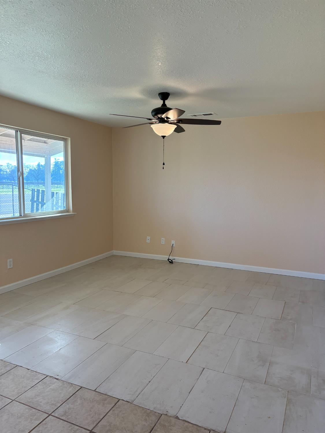 4654 Powerline Road Olivehurst, CA 95961 - Photo 4 of 16 a view of a livingroom with a ceiling fan and window