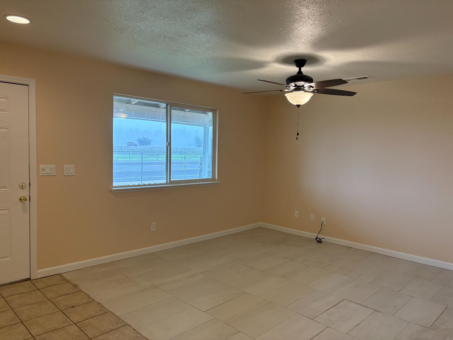 4654 Powerline Road Olivehurst, CA 95961 - Photo 5 of 14 a view of a room with a ceiling fan and a window