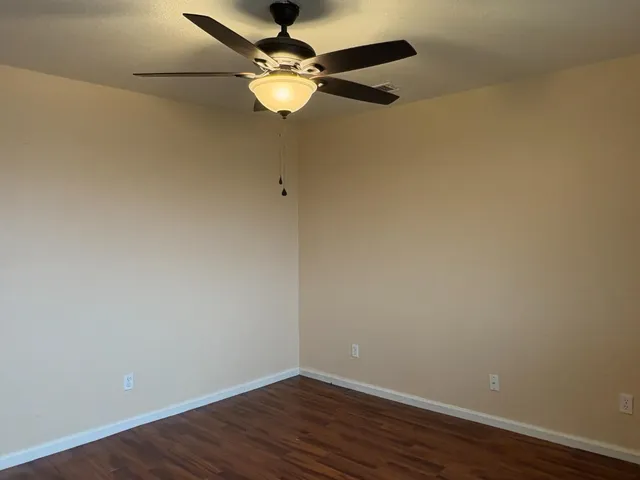 a view of a room with wooden floor