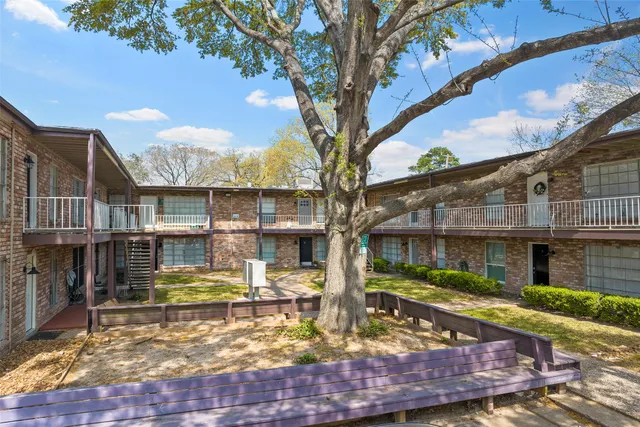 a view of a house with a yard balcony and tree s