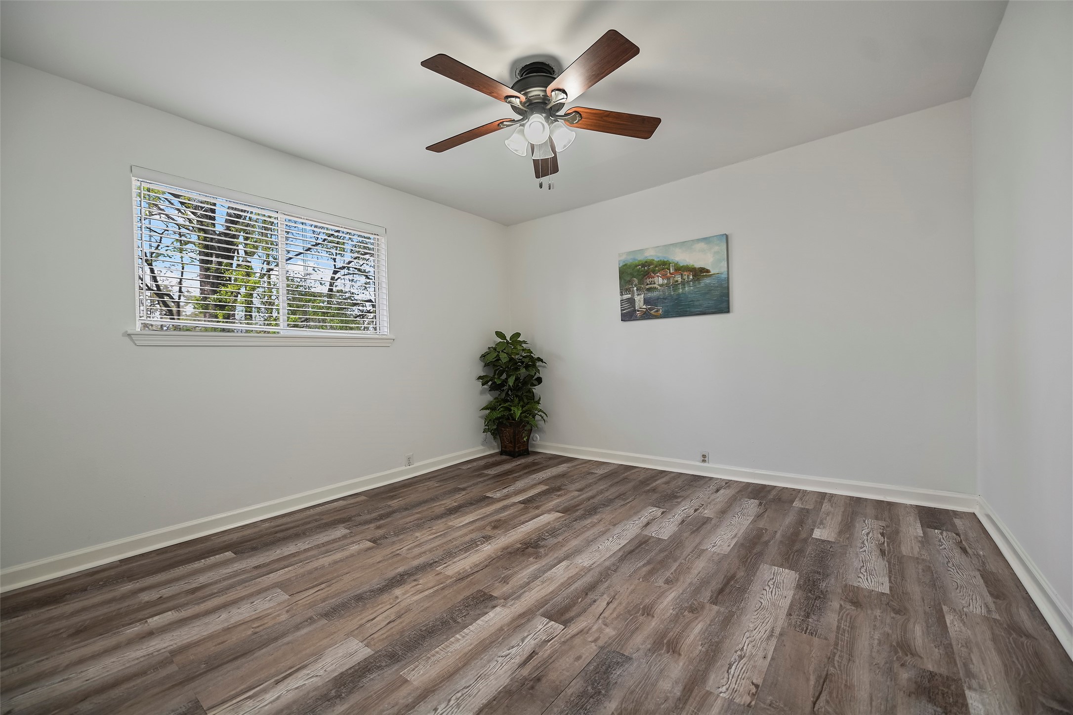 7510 Shadyvilla Lane, Unit 23 Houston, TX 77055 - Photo 13 of 23 a view of an empty room with window and wooden floor