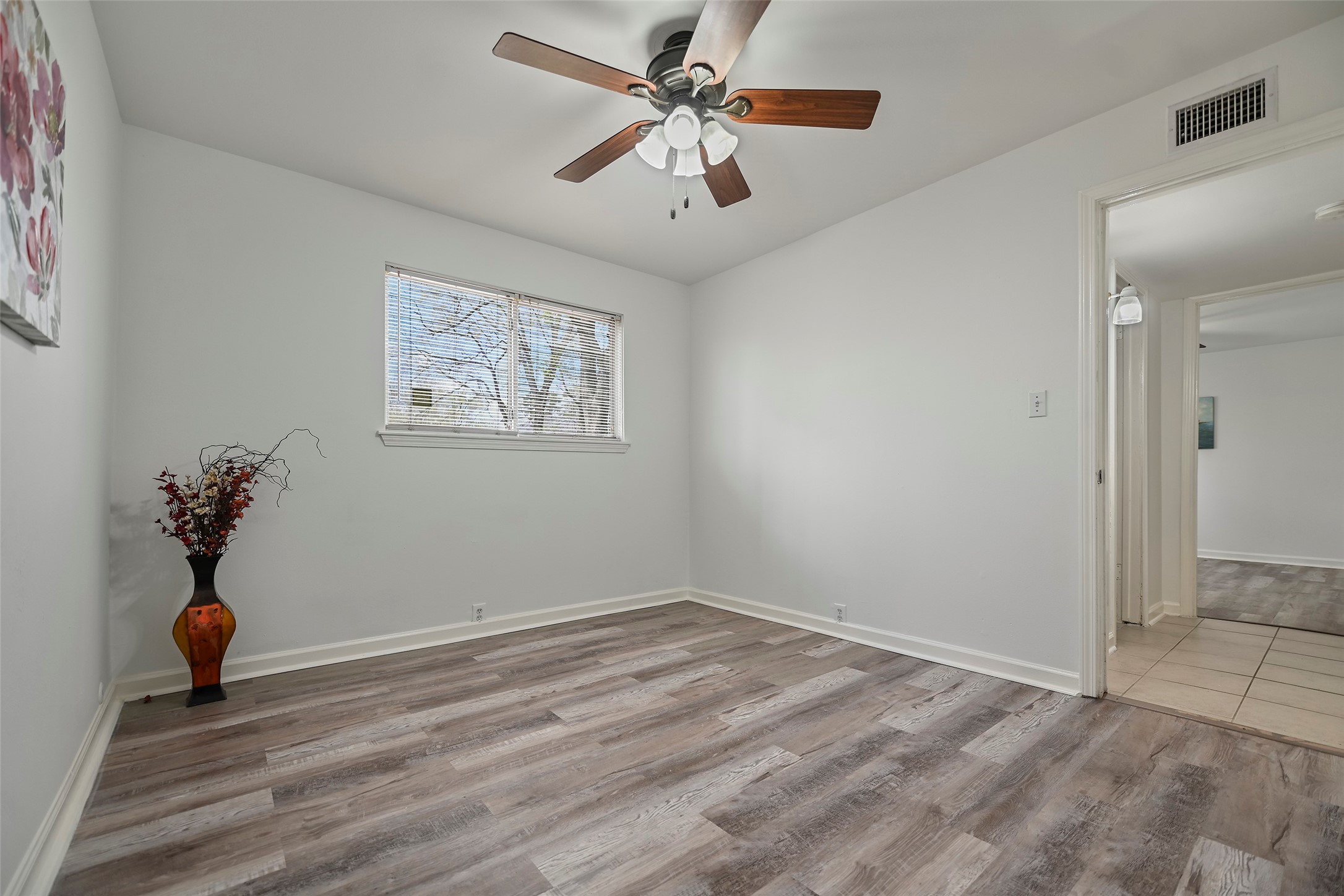 7510 Shadyvilla Lane, Unit 23 Houston, TX 77055 - Photo 20 of 23 wooden floor in an empty room with a window
