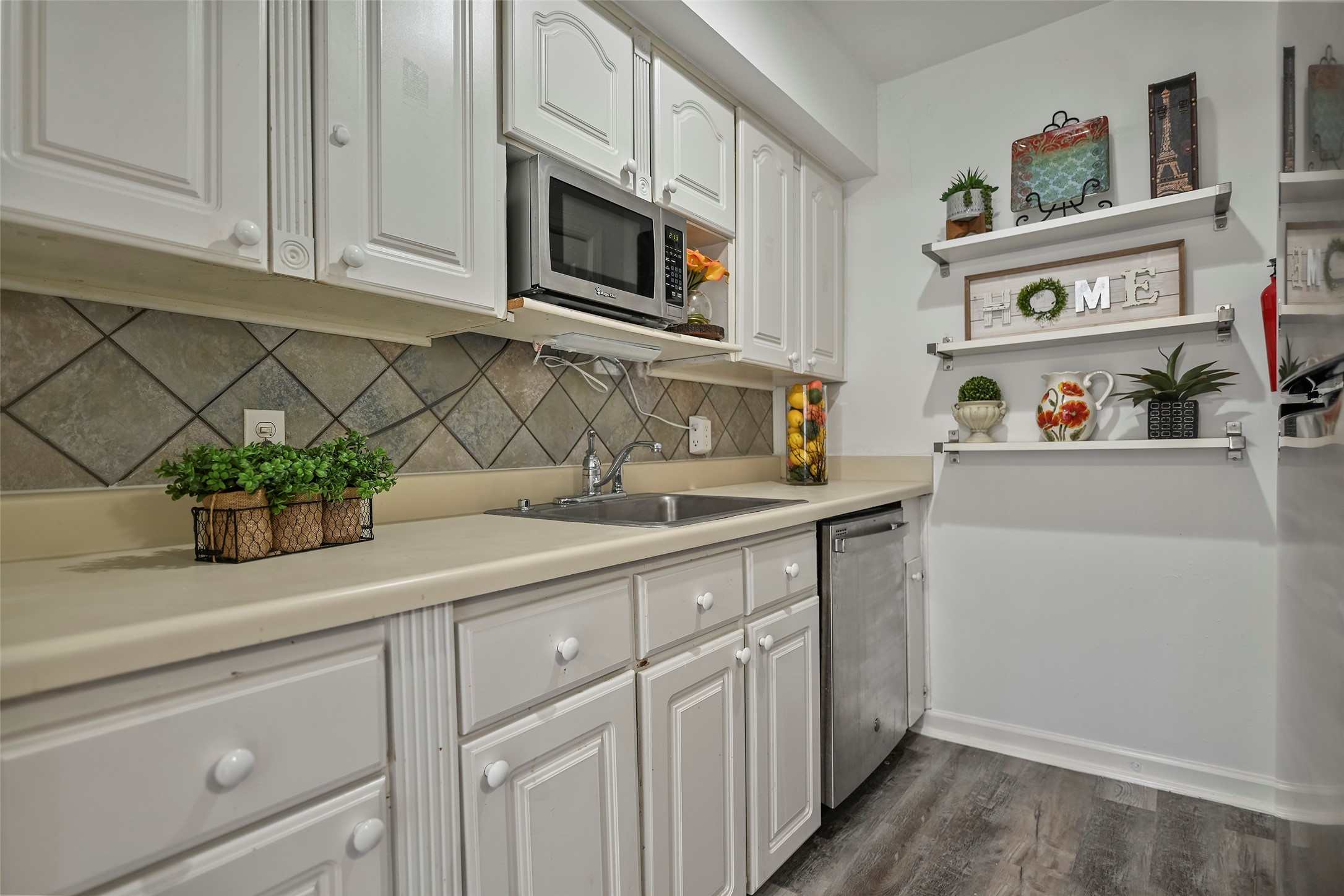 7510 Shadyvilla Lane, Unit 23 Houston, TX 77055 - Photo 9 of 23 a kitchen with stainless steel appliances white cabinets and a sink