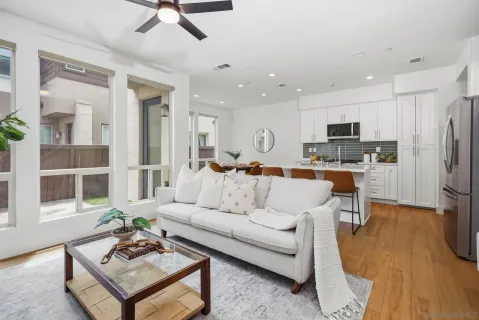 a living room with stainless steel appliances kitchen island furniture and a view of kitchen