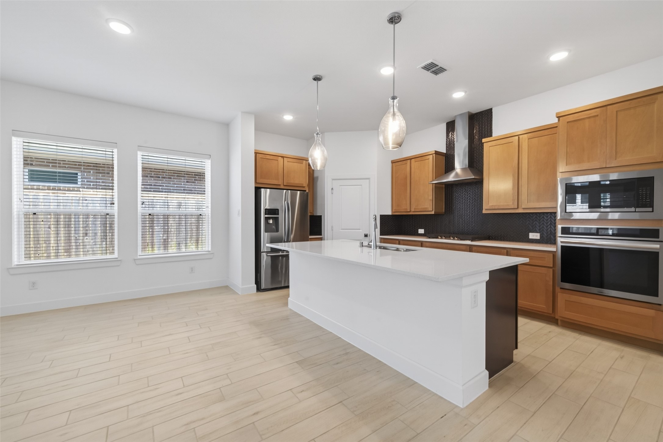 211 Amaranth Way Richmond, TX 77406 - Photo 15 of 26 a large kitchen with stainless steel appliances kitchen island granite countertop a stove a sink a refrigerator and a granite counter tops with white cabinets