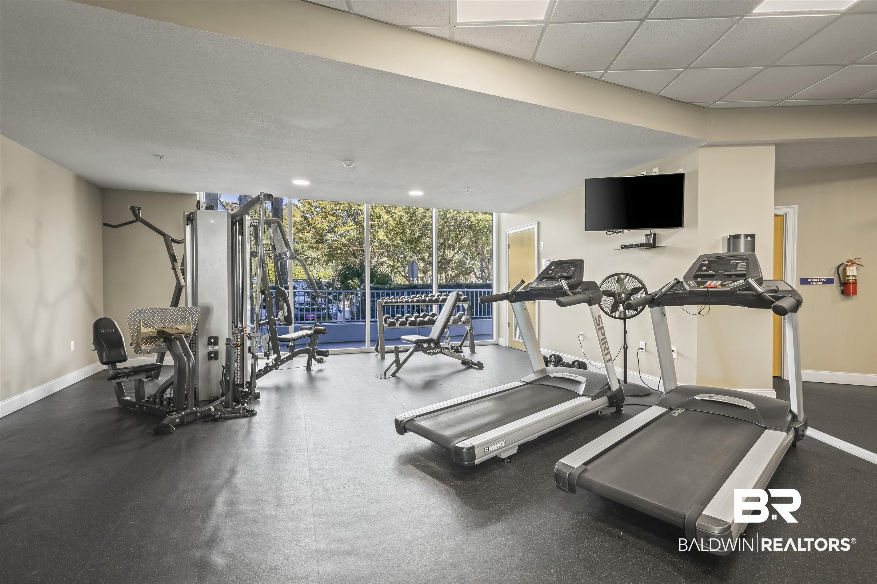 27800 Canal Road, Unit 120 Orange Beach, AL 36561 - Photo 47 of 68 Workout area featuring floor to ceiling windows and a paneled ceiling