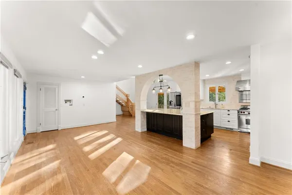 a kitchen with kitchen island a sink stainless steel appliances and cabinets