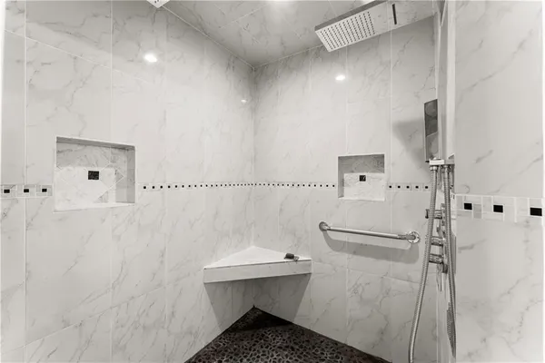 a bathroom with a double vanity sink a mirror and bathtub