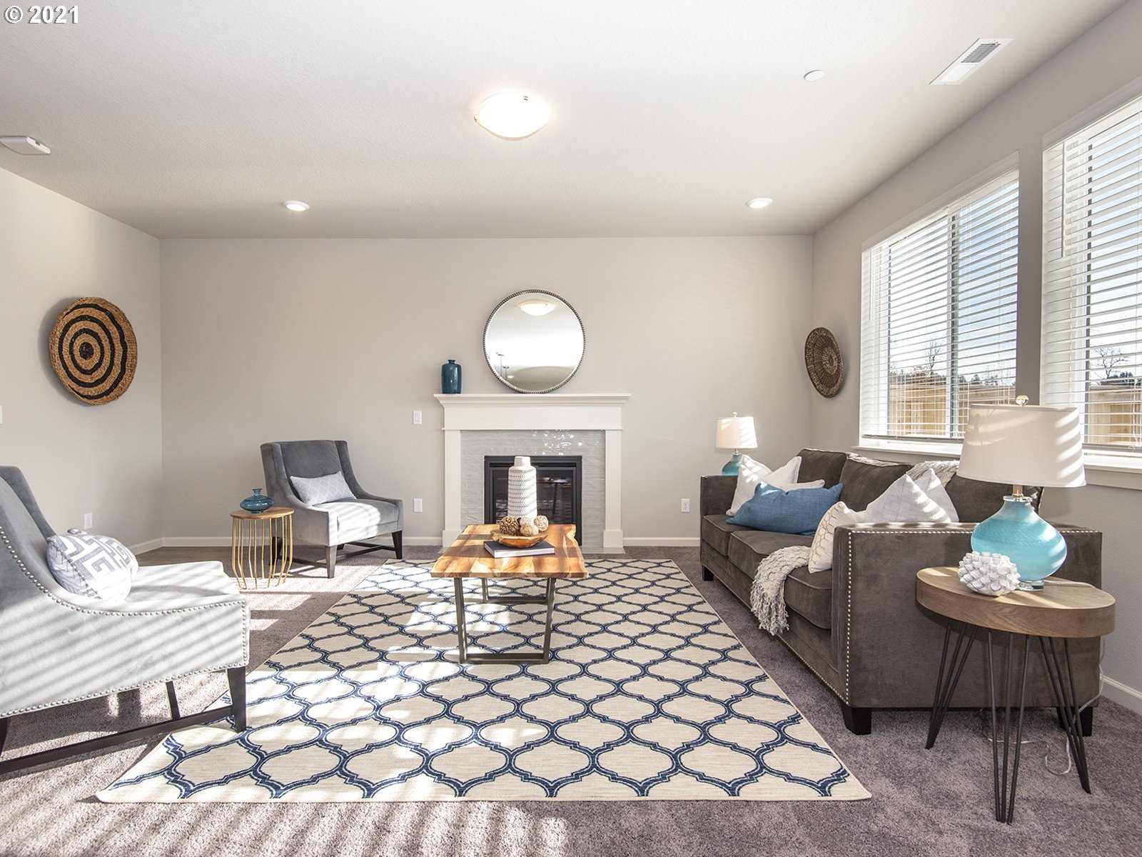 3800 South 43rd Place Ridgefield, WA 98642 - Photo 5 of 28 a living room with furniture a fireplace and a large mirror next to a window