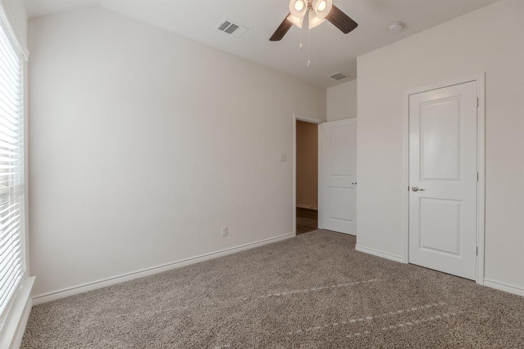 2902 Trusting Way Aubrey, TX 76227 - Photo 20 of 38 Carpeted interior space featuring a vaulted ceiling and a ceiling fan with light fixture