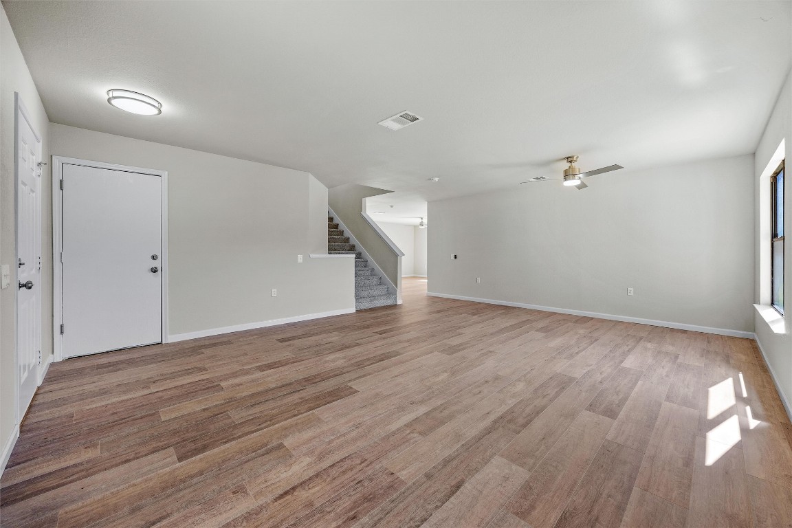7541 Redrick Drive Austin, TX 78747 - Photo 12 of 40 a view of a room with wooden floor and white walls