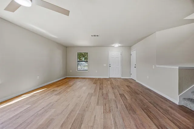 a view of an empty room and wooden floor