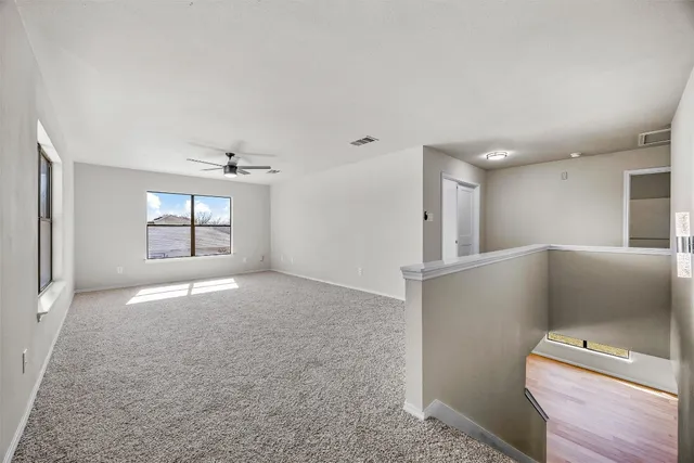 a view of a livingroom with a ceiling fan and window