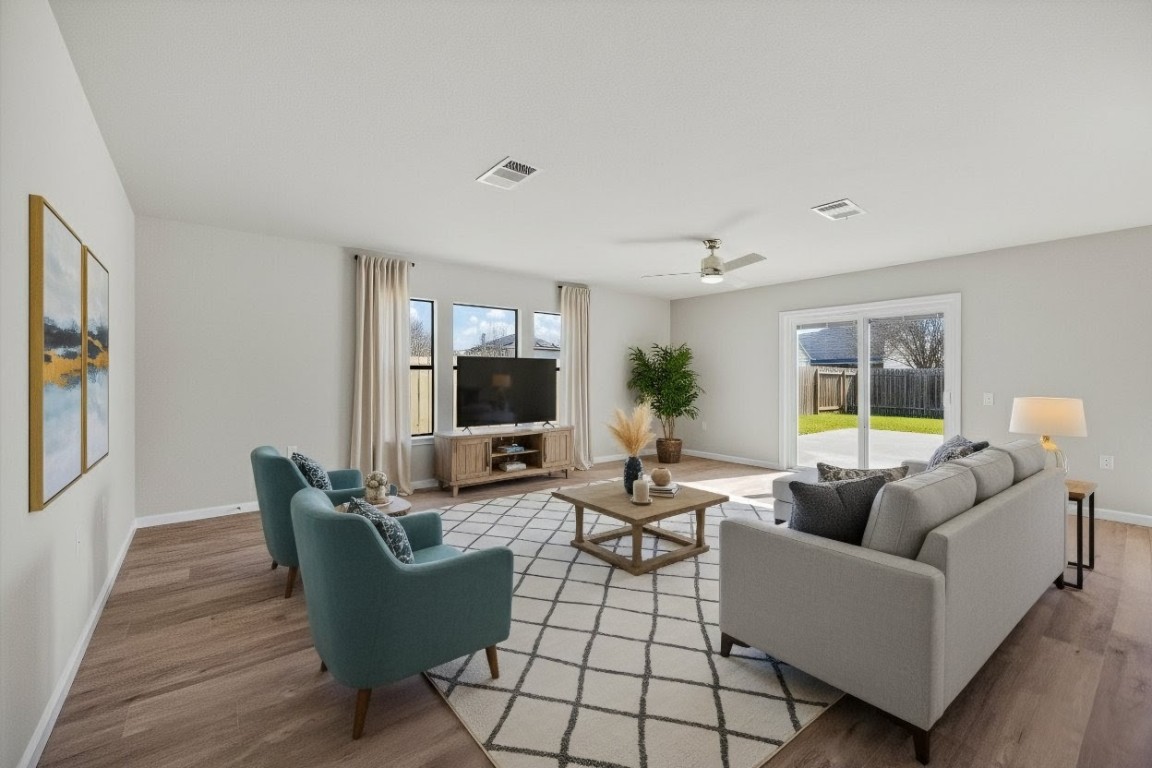 7541 Redrick Drive Austin, TX 78747 - Photo 5 of 40 a living room with furniture a flat screen tv and a large window