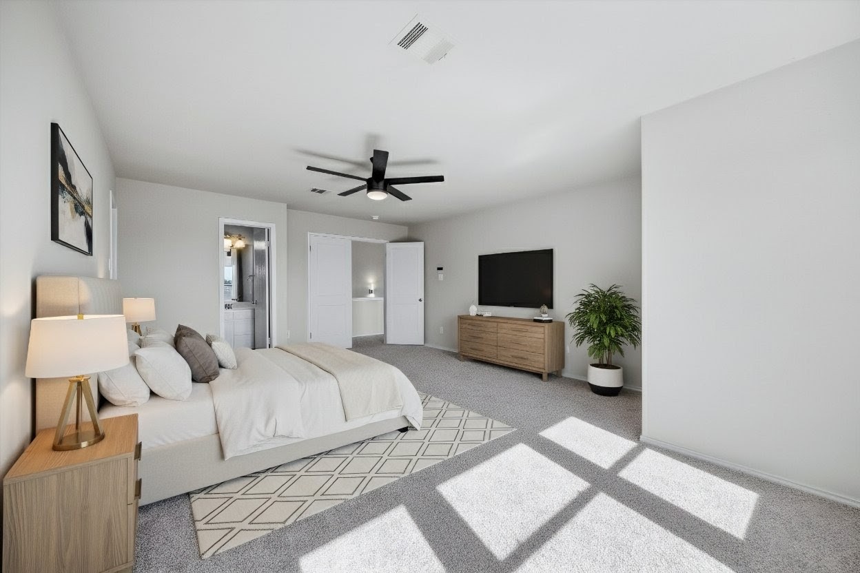 7541 Redrick Drive Austin, TX 78747 - Photo 8 of 40 a bedroom with a bed a couch and a flat screen tv