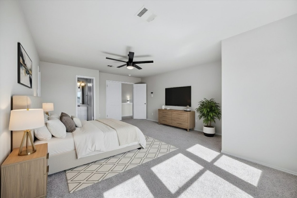 7541 Redrick Drive Austin, TX 78747 - Photo 8 of 40 a bedroom with a bed a couch and a flat screen tv