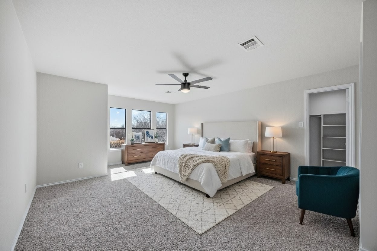 7541 Redrick Drive Austin, TX 78747 - Photo 9 of 40 a spacious bedroom with a bed a couch and window