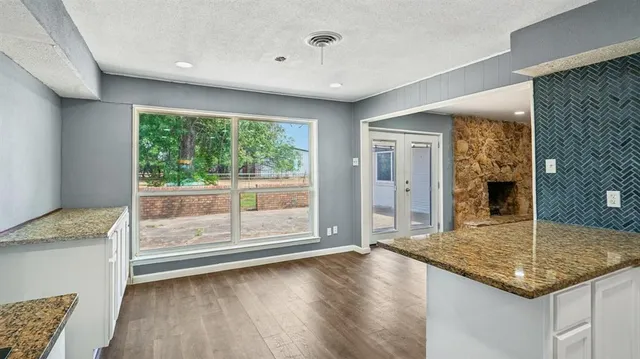 a view of a hallway with wooden floor and doors