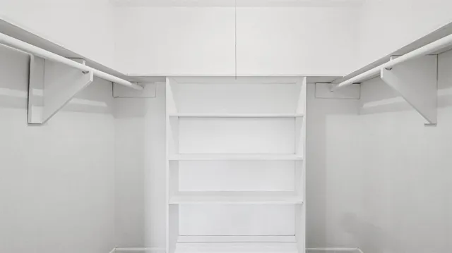 a bathroom with a granite countertop toilet and a sink