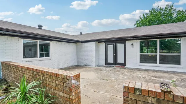 a front view of house with yard and trees