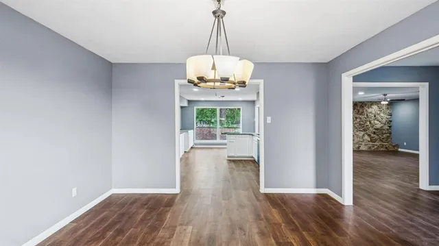 a view of livingroom with chandelier wooden floor and a chandelier