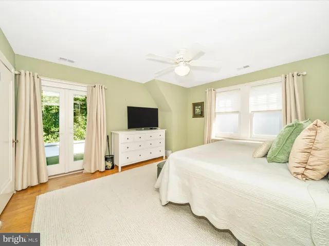 a living room with dining room and wooden floor