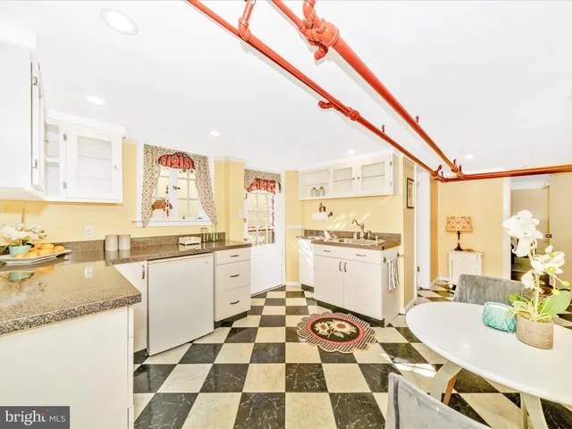 a building outdoor space with patio furniture and potted plants