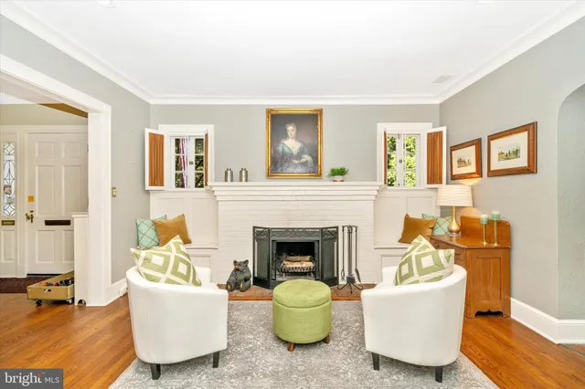 a dining room with furniture a chandelier and wooden floor