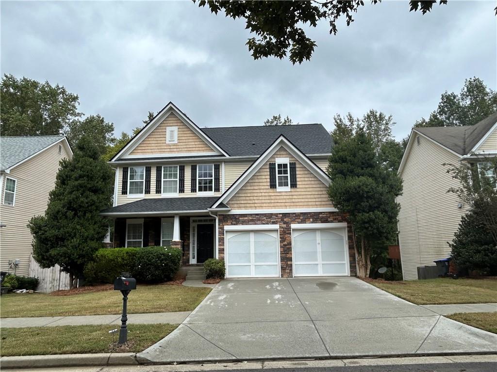 a front view of a house with a yard and garage