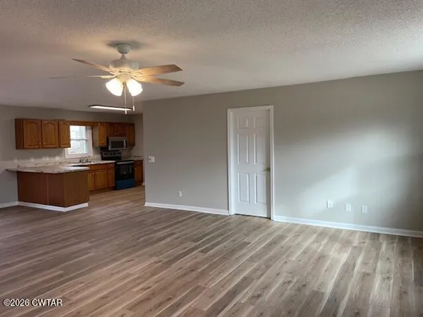 a view of a kitchen with a stove cabinets and wooden floor