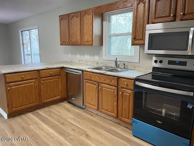a kitchen with a sink stove and microwave