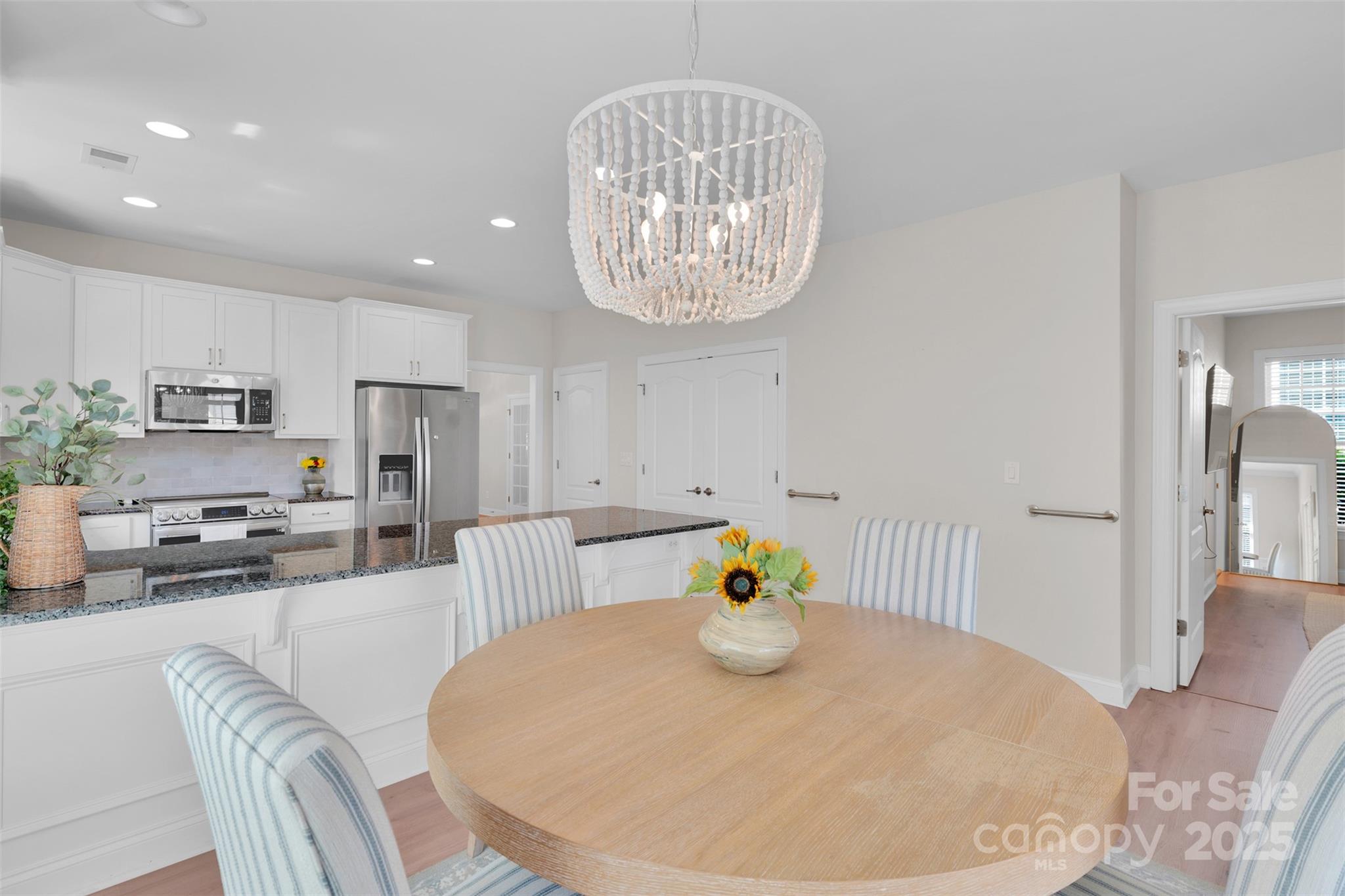 13415 Hazelbrook Lane Cornelius, NC 28031 - Photo 11 of 29 a view of dining room and kitchen island with stainless steel appliances
