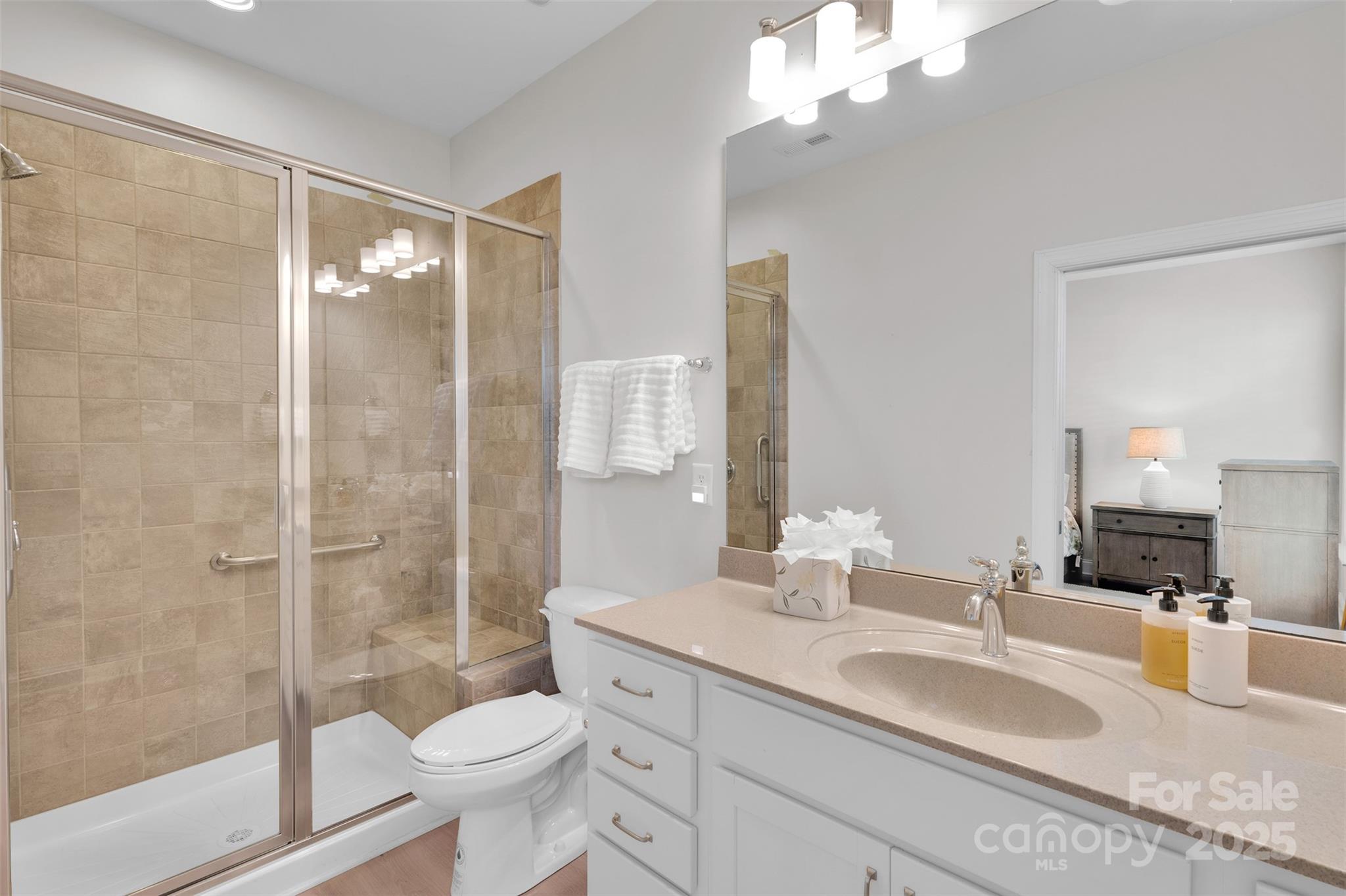 13415 Hazelbrook Lane Cornelius, NC 28031 - Photo 16 of 29 a bathroom with a double vanity sink toilet and shower