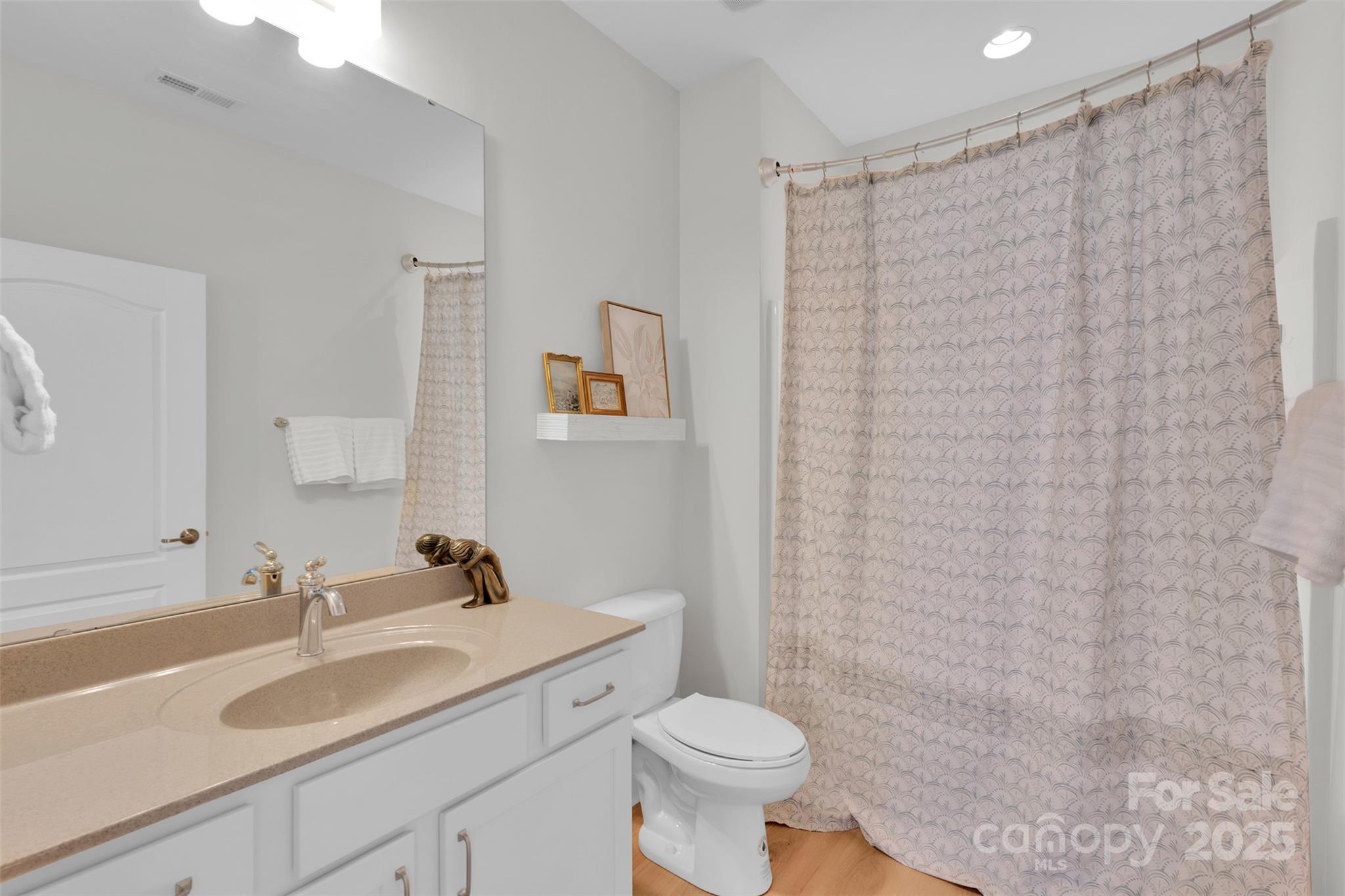 13415 Hazelbrook Lane Cornelius, NC 28031 - Photo 21 of 29 a bathroom with a sink a toilet and shower