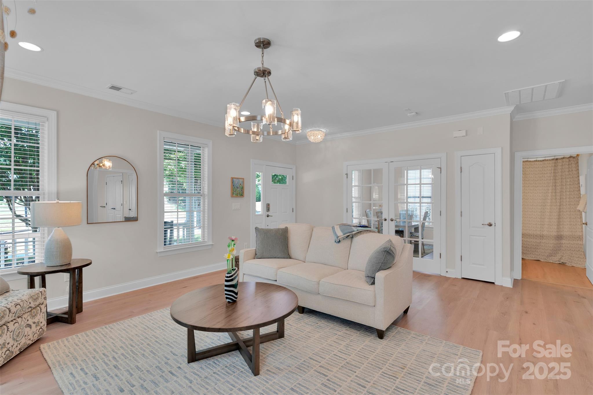 13415 Hazelbrook Lane Cornelius, NC 28031 - Photo 4 of 29 a living room with furniture and a chandelier