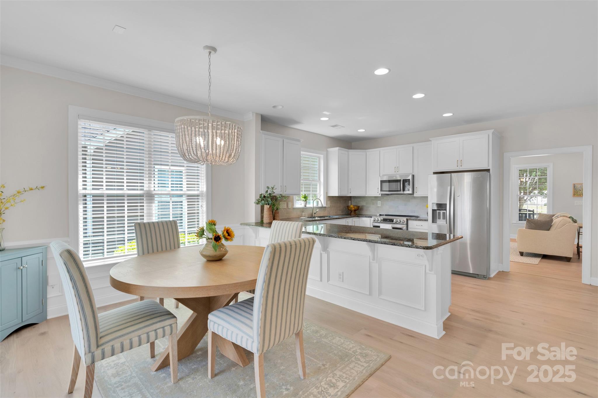 13415 Hazelbrook Lane Cornelius, NC 28031 - Photo 10 of 29 a kitchen with stainless steel appliances kitchen island granite countertop a dining table chairs stove refrigerator and cabinets