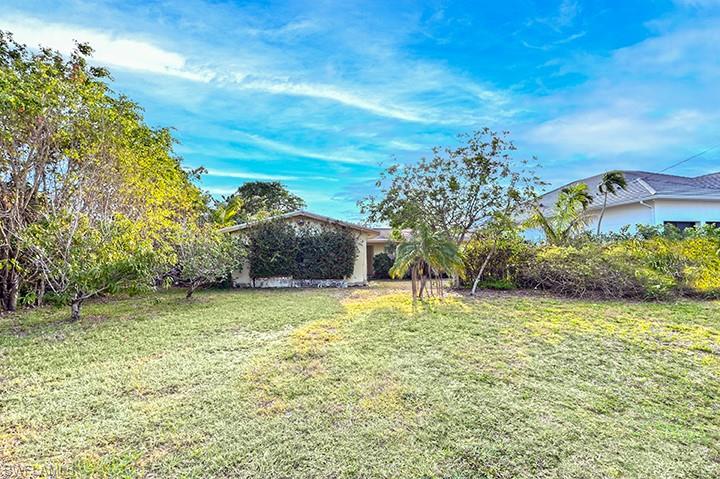 2165 Tarpon Road Naples, FL 34102 - Photo 4 of 4 a backyard of a house with lots of green space