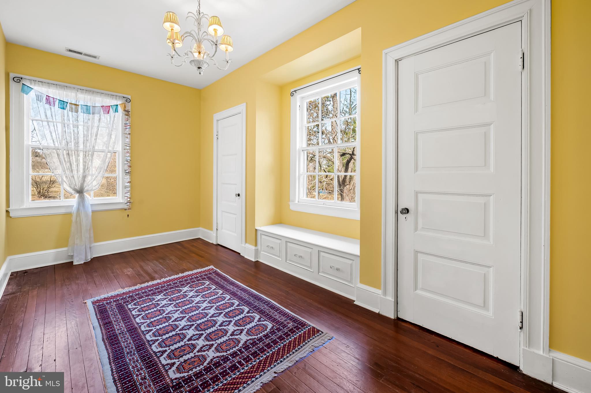 1605 Terrace Road Baltimore, MD 21209 - Photo 34 of 45 a view of an empty room with a window and wooden floor