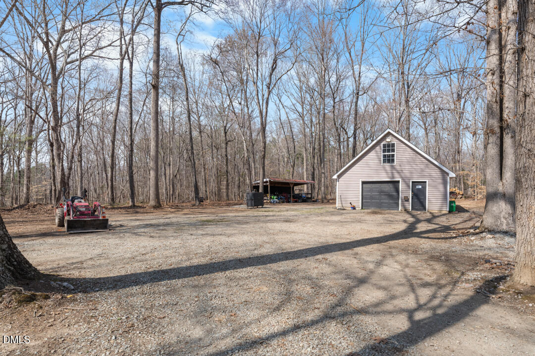4739 Wild Azalea Place Rougemont, NC 27572 - Photo 40 of 48 a view of a house with trees in front of it