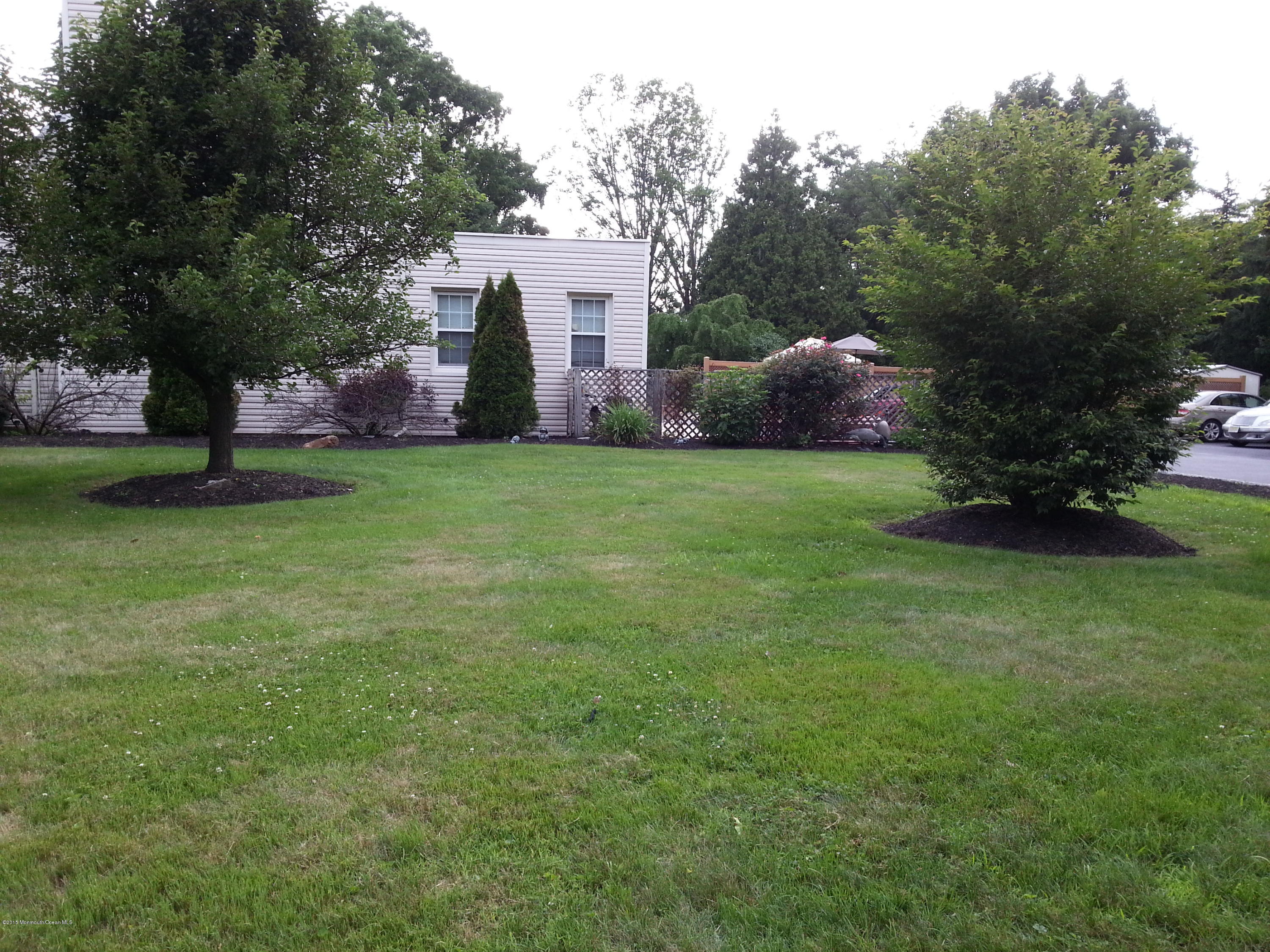 8 Sherwood Road Colonia, NJ 07067 - Photo 8 of 15 a backyard of a house with plants and large trees