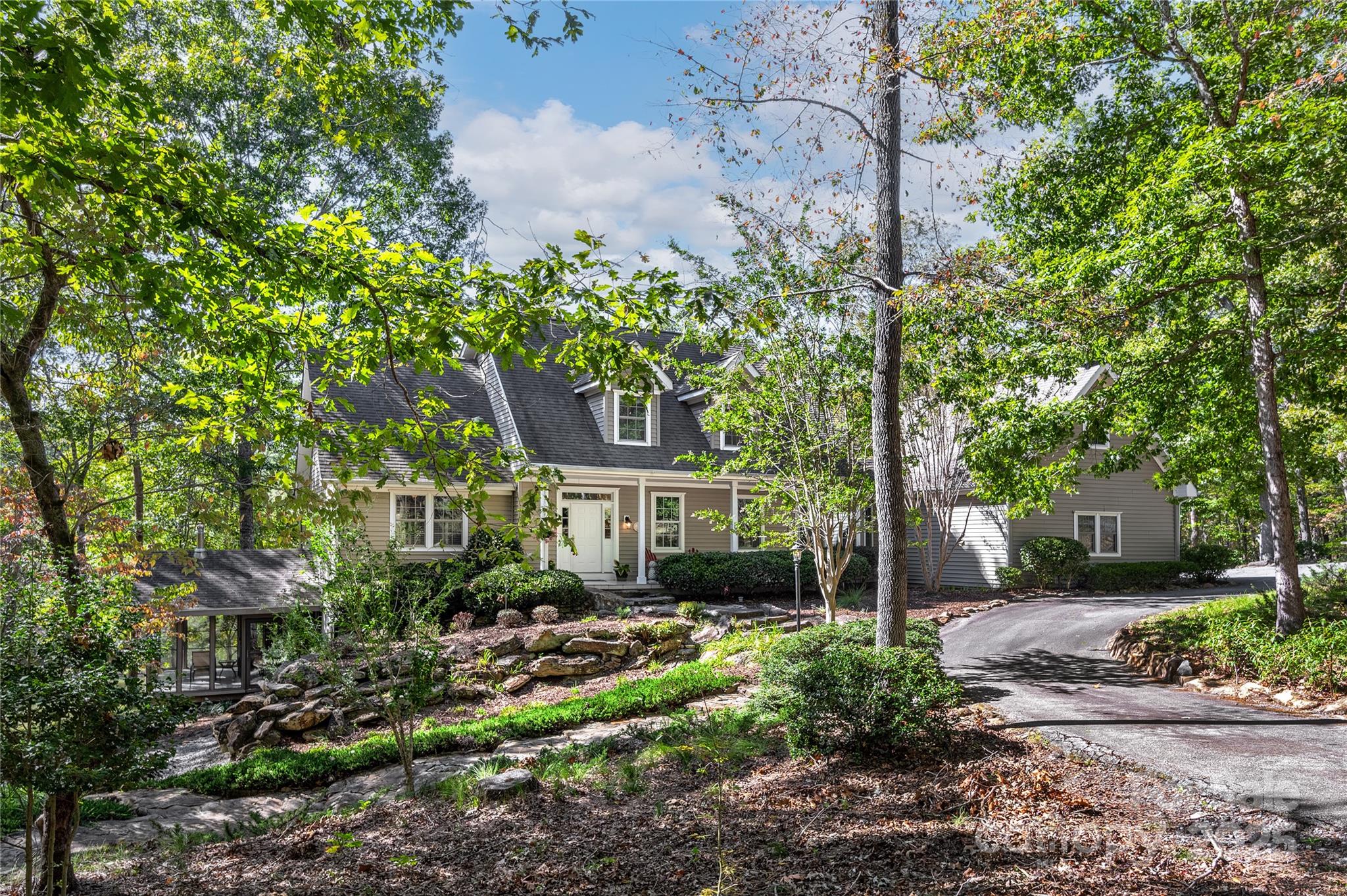 a house is sitting in middle of forest