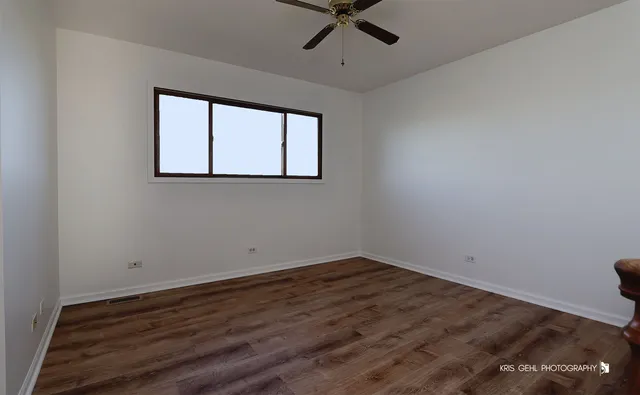 a view of a room with wooden floor and windows