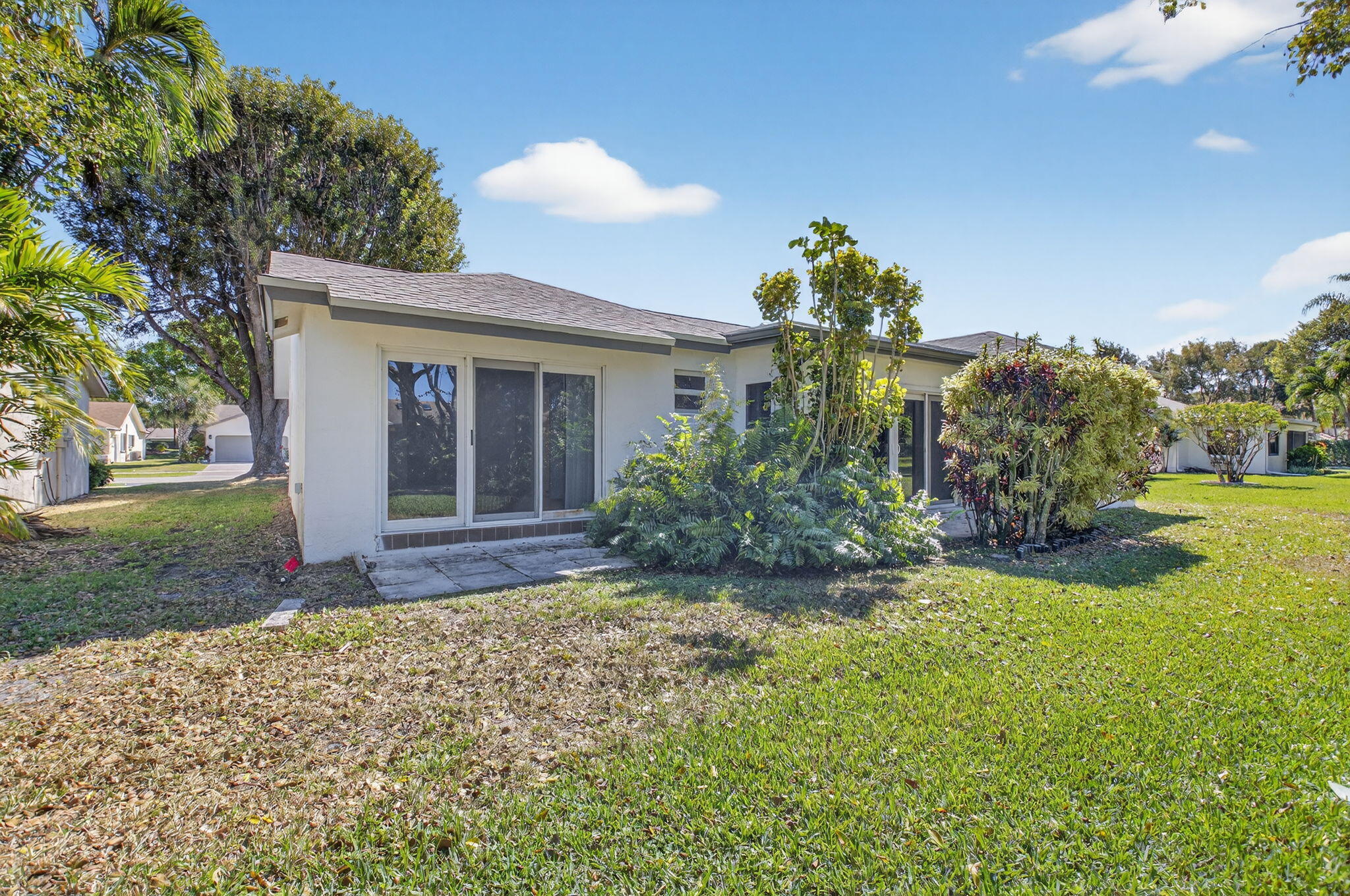 18093 104th Terrace South Boca Raton, FL 33498 - Photo 35 of 43 a view of a house with a yard and a garden