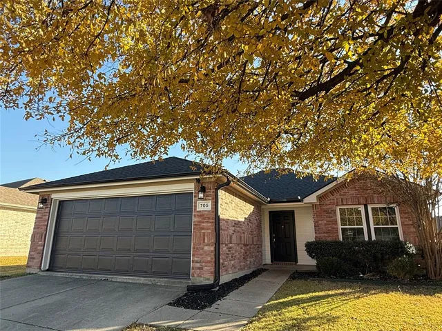 a front view of a house with yard and garage