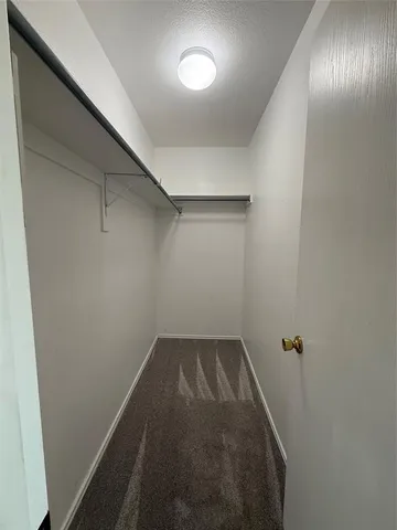 a view of a livingroom with a ceiling fan and window