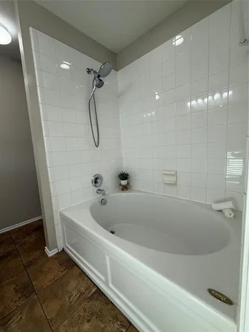 a bathroom with a double vanity sink toilet mirror and bathtub