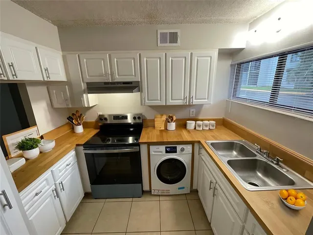 a kitchen with a stove and a sink