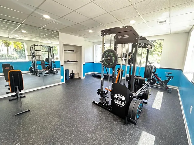 a room with gym equipment and a large window