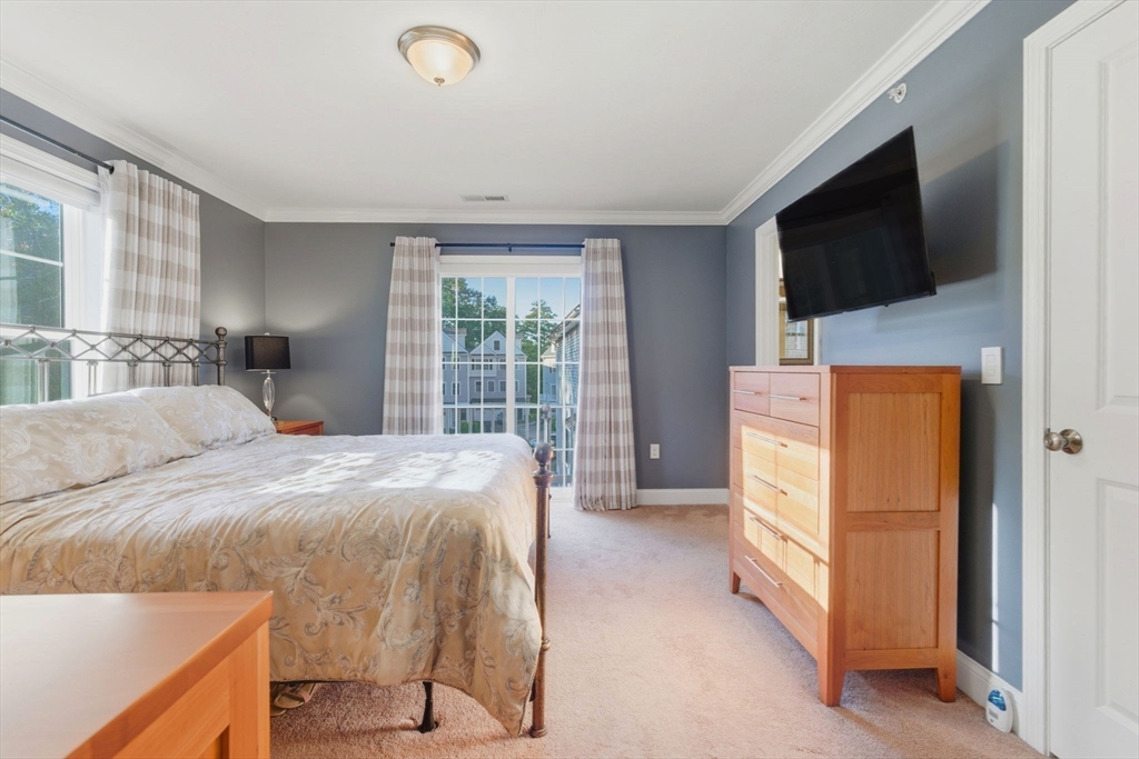 66 Compass Point, Unit 66 North Andover, MA 01845 - Photo 29 of 42 a bedroom with a bed and a flat screen tv